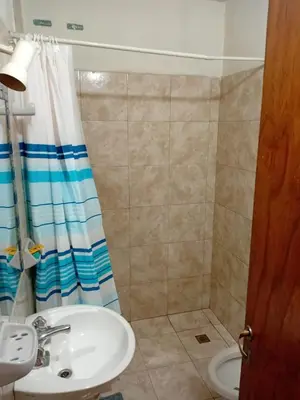 a bathroom with a sink and a shower curtain at Depto Alto Verde in Cordoba