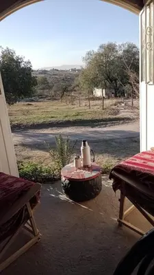 a patio with a table and a view of a field at Casa de campo La Mary in Tanti