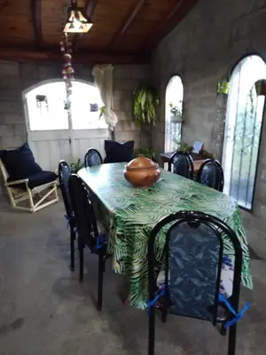 a table with chairs and a bowl on top of it at Casa de campo La Mary in Tanti