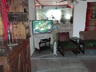 a living room with a tv and a table and chairs at Casa de campo La Mary in Tanti
