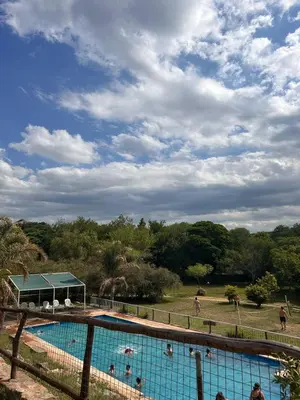 a large swimming pool with people playing in it at Cabañas Ensueño in Villa Carlos Paz