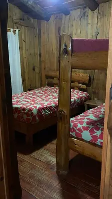 a bedroom with two bunk beds in a cabin at Cabañas Ensueño in Villa Carlos Paz