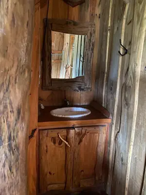 a bathroom with a sink and a mirror at Cabañas Ensueño in Villa Carlos Paz