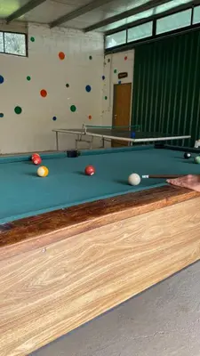 a pool table with balls on top of it at Cabañas Ensueño in Villa Carlos Paz