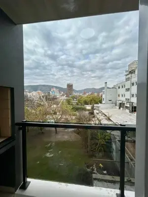 a view of a city from a window at Flat with Pool, Gym & Great Views in Villa Carlos Paz