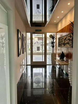 a hallway with a table and a glass door at Flat with Pool, Gym & Great Views in Villa Carlos Paz
