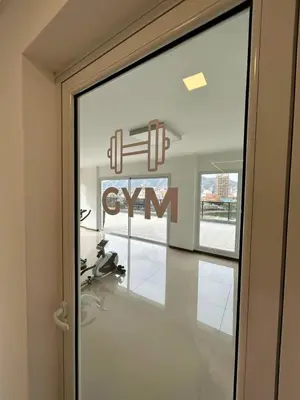 a glass door with a gym sign on it at Flat with Pool, Gym & Great Views in Villa Carlos Paz