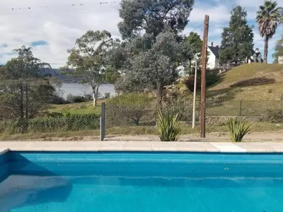 a swimming pool with a view of the water at La Casa del Lago in Villa Santa Cruz del Lago