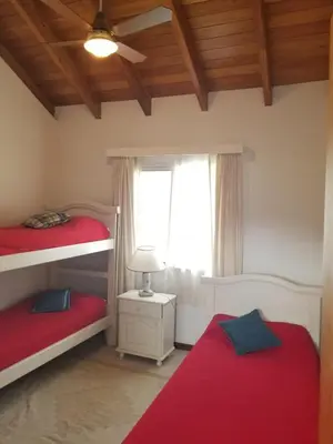 a bedroom with two bunk beds and a window at La Casa del Lago in Villa Santa Cruz del Lago