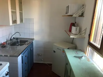 a small kitchen with a sink and a refrigerator at Departamento barrio urca in Cordoba
