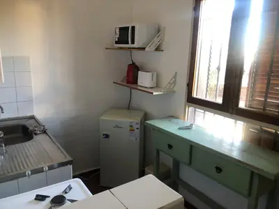 a small kitchen with a refrigerator and a microwave at Departamento barrio urca in Cordoba