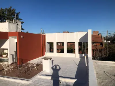 a shadow of a person standing on the roof of a building at Departamento barrio urca in Cordoba