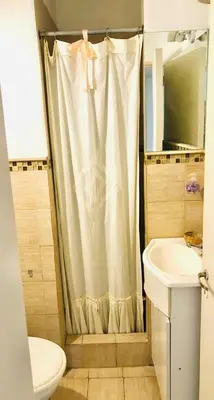 a bathroom with a shower curtain and a sink at Departamento barrio urca in Cordoba