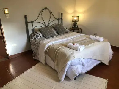 a bedroom with a large bed with two pillows at Departamento barrio urca in Cordoba