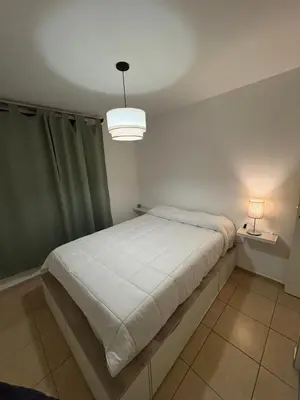 a bedroom with a large bed with a white blanket at Departamento Excelente Ubicación ! in Cordoba