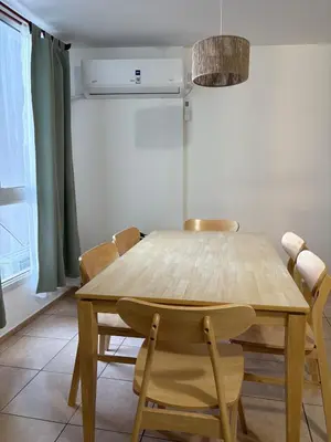 a wooden table and chairs in a room at Departamento Excelente Ubicación ! in Cordoba