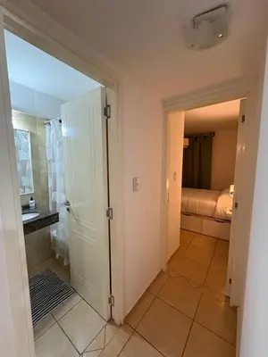 a bathroom with a door leading to a bedroom at Departamento Excelente Ubicación ! in Cordoba
