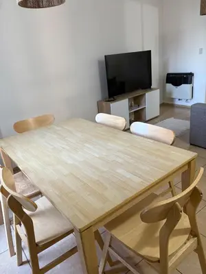 a wooden table and chairs in a living room at Departamento Excelente Ubicación ! in Cordoba