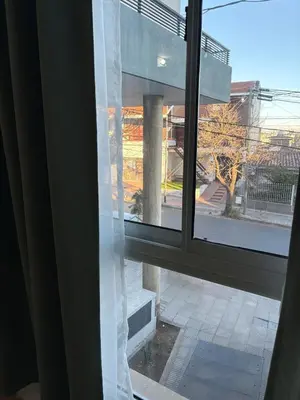 a window with a view of a building at Departamento Excelente Ubicación ! in Cordoba