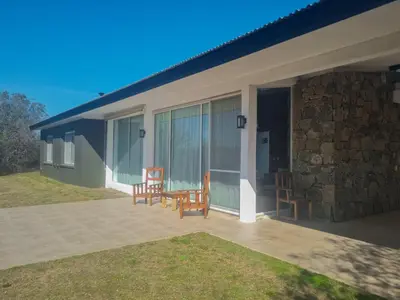 a house with two chairs and a patio at Las Negritas, Casas de Montaña in La Estancia