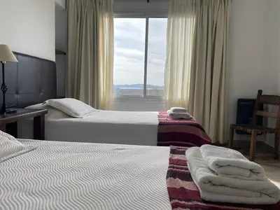a hotel room with two beds and a window at Las Negritas, Casas de Montaña in La Estancia