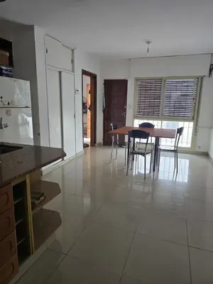 a kitchen and dining room with a table and chairs at Departamento - Cerro de las Rosas, Cordoba - 5 personas in Cordoba