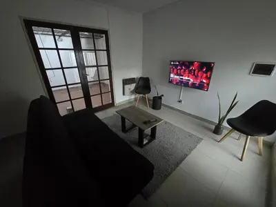 a living room with a couch and a tv at Departamento - Cerro de las Rosas, Cordoba - 5 personas in Cordoba