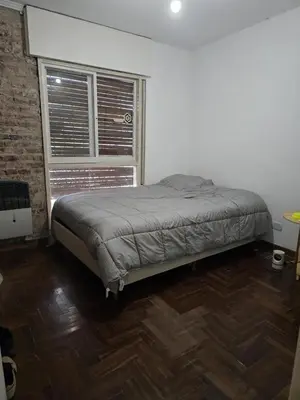 a bed sitting in a room with a window at Departamento - Cerro de las Rosas, Cordoba - 5 personas in Cordoba