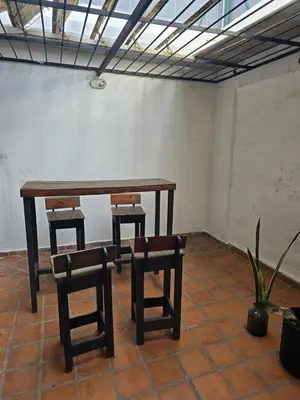 a table and two chairs in a room at Departamento - Cerro de las Rosas, Cordoba - 5 personas in Cordoba
