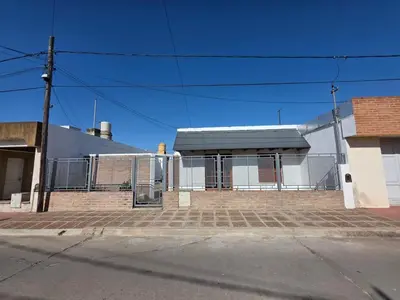 a building with a gate in front of a street at RS Home in Río Cuarto