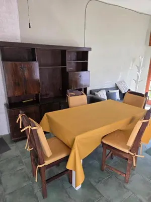a table and chairs with a yellow table cloth on it at RS Home in Río Cuarto