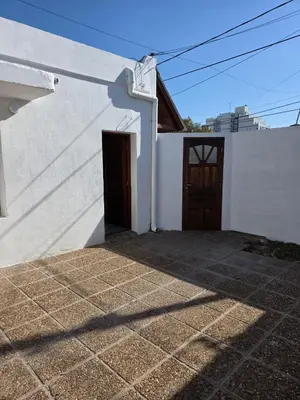 a white building with a doorway and a door at RS Home in Río Cuarto