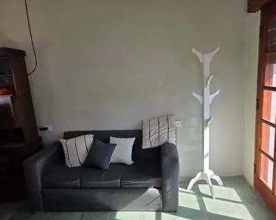 a living room with a gray couch and a lamp at RS Home in Río Cuarto