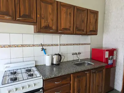a kitchen with a stove and a sink at RS Home in Río Cuarto