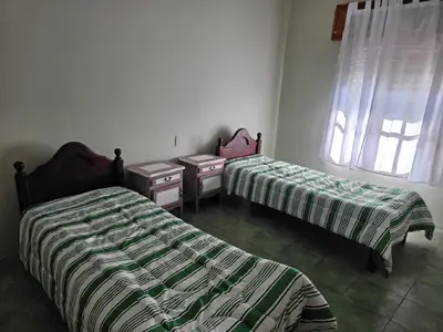 two beds sitting next to each other in a room at RS Home in Río Cuarto