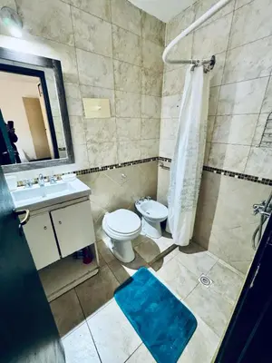 a bathroom with a toilet and a sink and a shower at Apartment in Nueva Córdoba in Cordoba