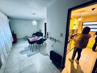 a woman is standing in a kitchen with a table at Apartment in Nueva Córdoba in Cordoba