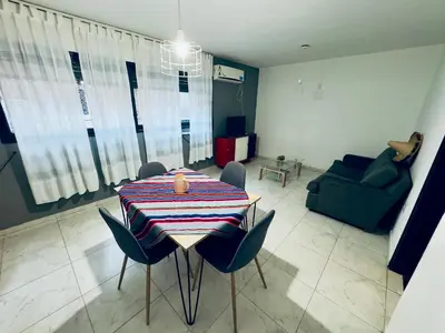 a living room with a table with chairs and a couch at Apartment in Nueva Córdoba in Cordoba