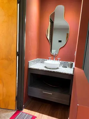 a bathroom with a sink and a mirror at Cabañas Antartida in Villa Carlos Paz