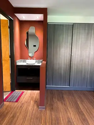 a bathroom with a sink and a mirror at Cabañas Antartida in Villa Carlos Paz