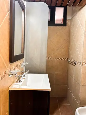 a bathroom with a sink and a mirror at Cabañas Antartida in Villa Carlos Paz