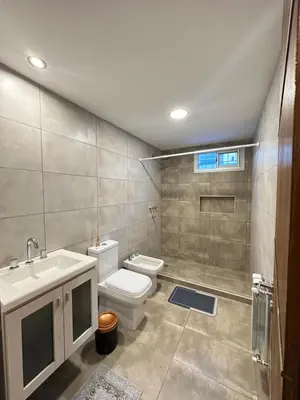 a bathroom with a toilet and a sink at Departamentos Sol y Lago in Villa Carlos Paz