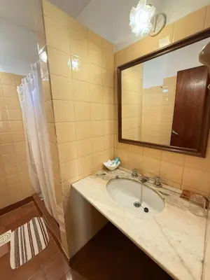 a bathroom with a sink and a mirror at Alta Montaña Hosteria&Apart in Los Hornillos