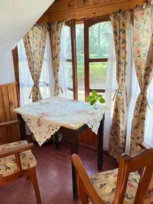 a table and chairs in a room with a window at Alta Montaña Hosteria&Apart in Los Hornillos