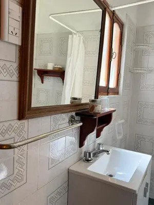 a bathroom with a sink and a mirror at Alta Montaña Hosteria&Apart in Los Hornillos