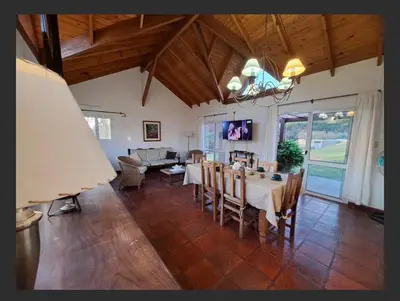a large living room with a table and chairs at Casa en las sierras de Merlo in Merlo