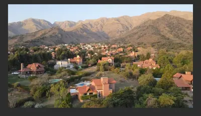 a small town with houses and mountains in the background at Casa en las sierras de Merlo in Merlo