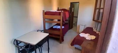 a small room with a small table and a small room with a bed at Posada in Merlo