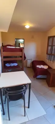a room with a bed and a table in a room at Posada in Merlo