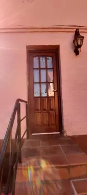 a door to a building with a staircase in front at Posada in Merlo